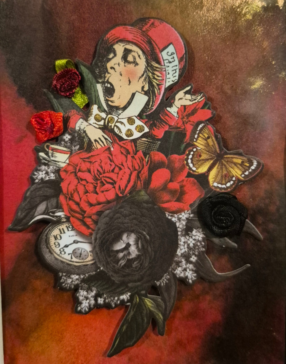 Decorative wall art with a man's face, flowers, and a butterfly on a dark background.